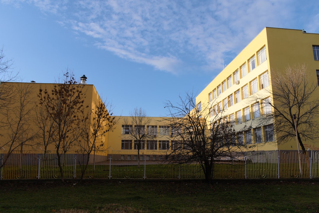 brown concrete building near green grass field during daytime