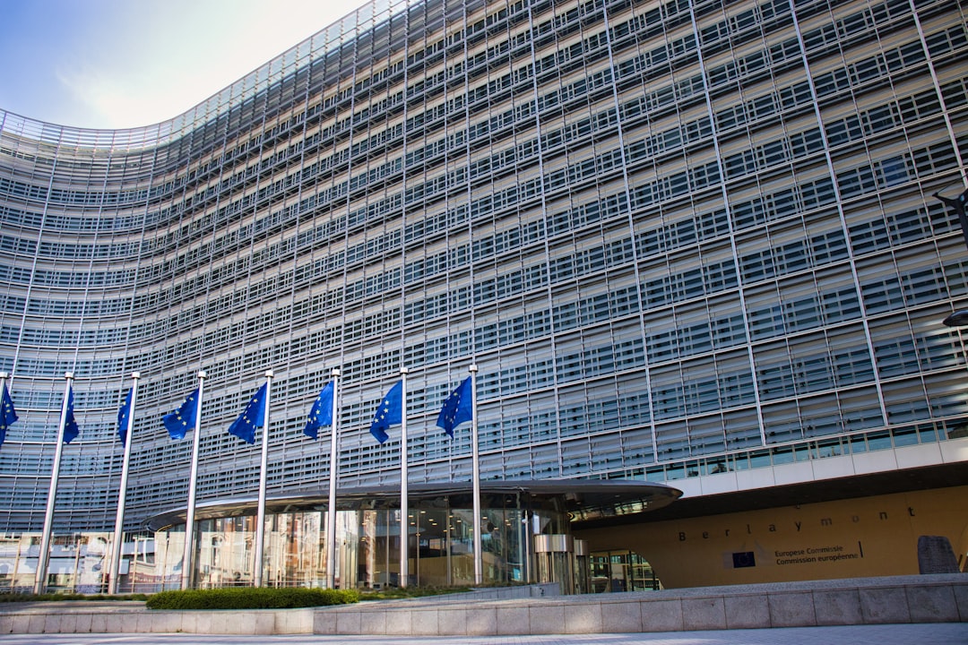 Modern glass building with european union flags