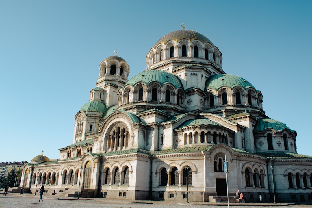 A large church sits beneath a clear blue sky.