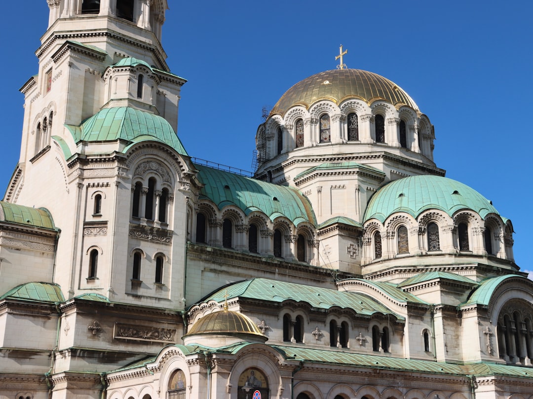 Large white cathedral with green and gold domes